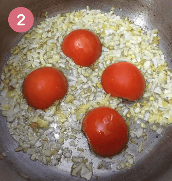 Step 1: Add tomatoes, cut in half, face down, into the pot [Pakistani Chicken Curry Recipe]